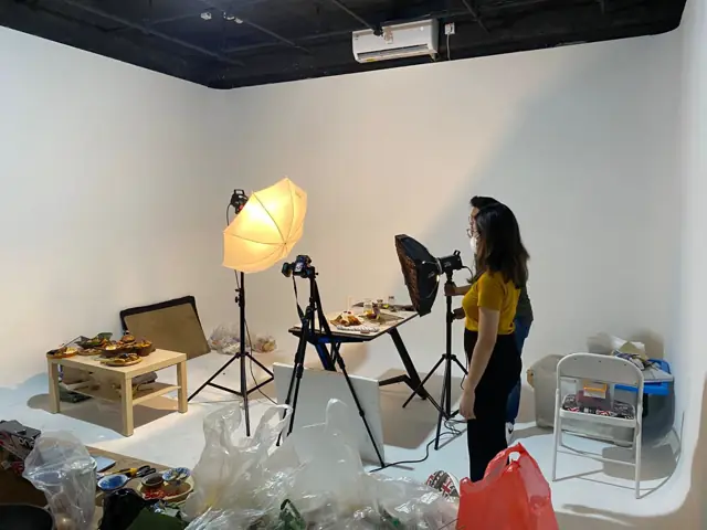 Photographer shooting in the white limbo studio
